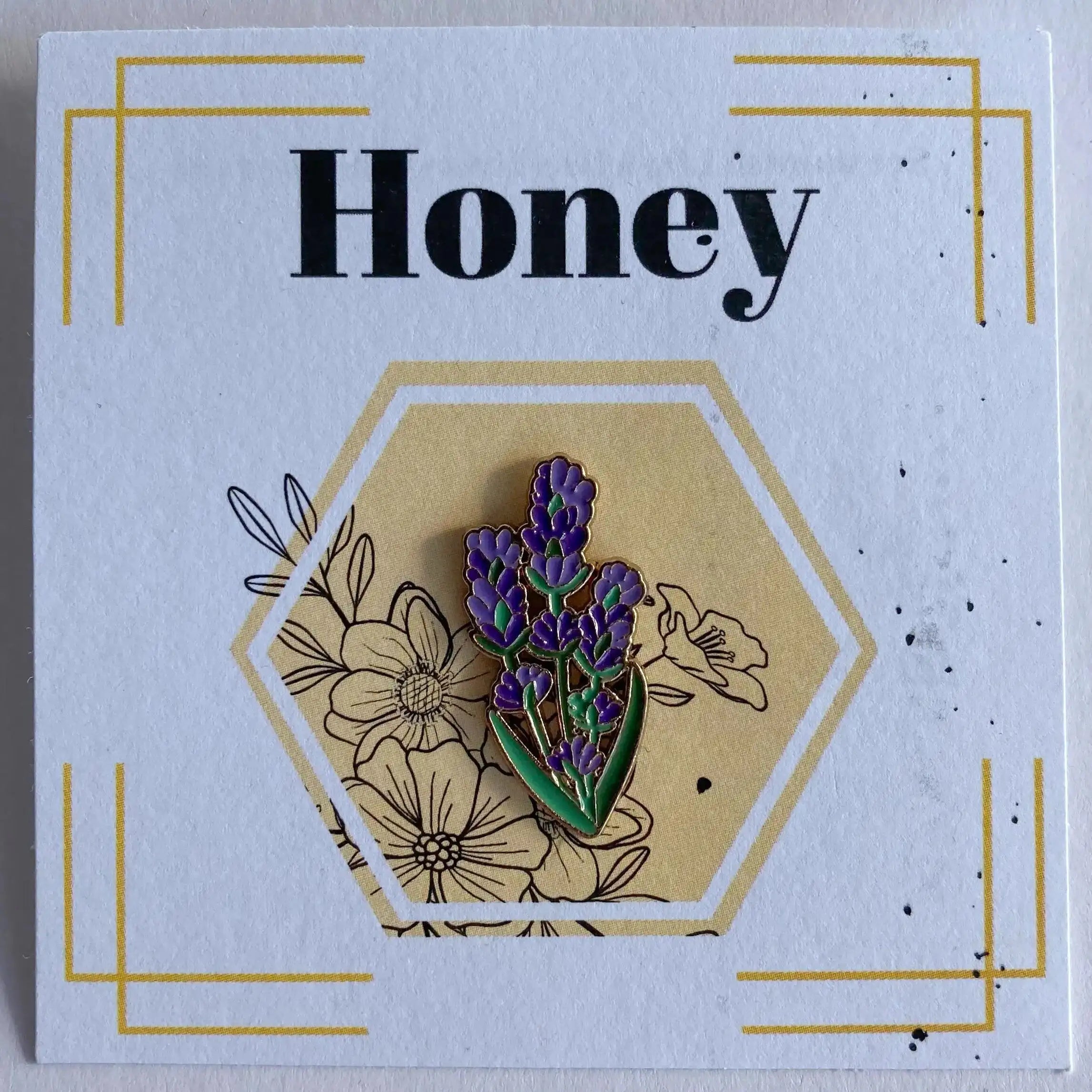 Floral pin on a card with 'Honey' text