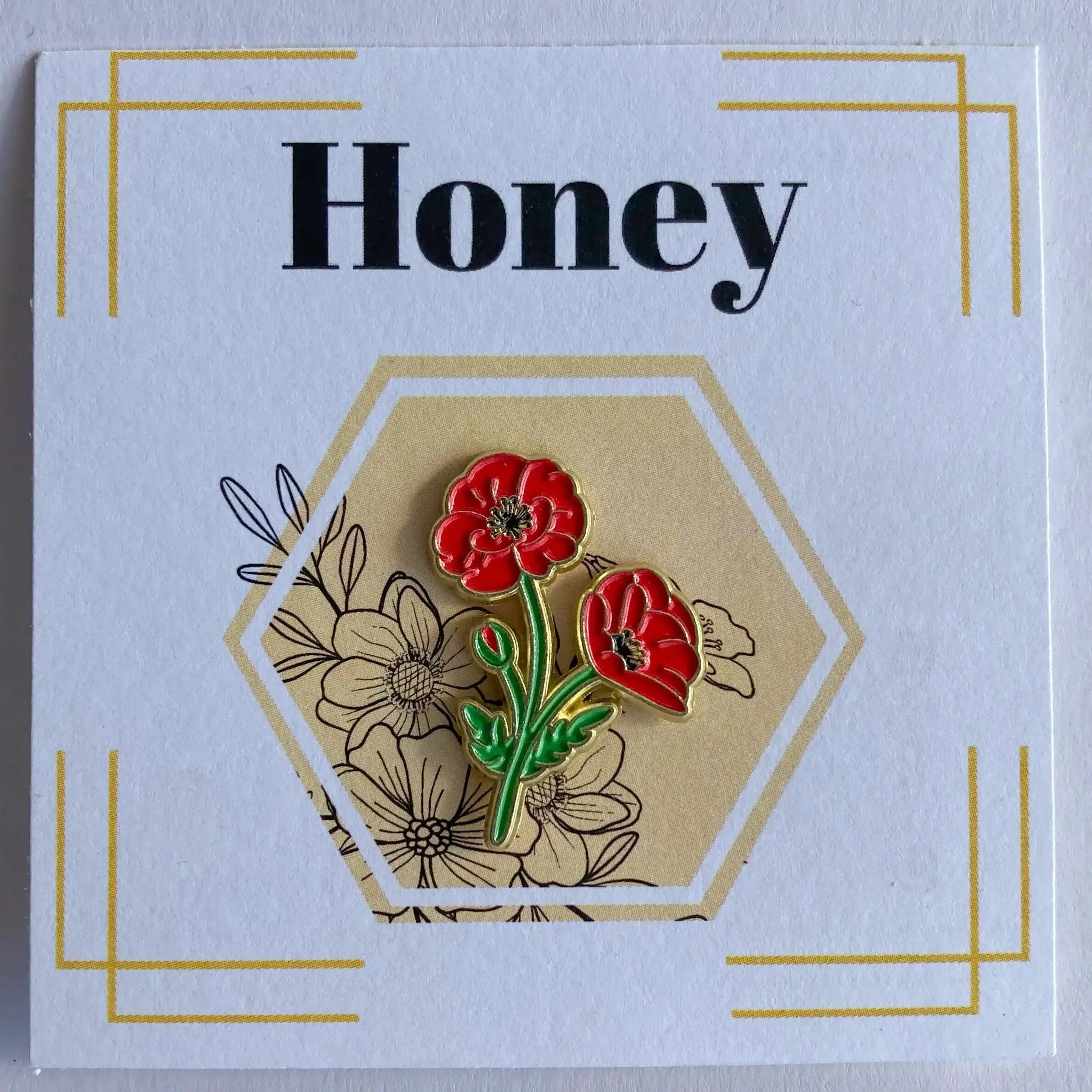 Floral pin on a card with 'Honey' text