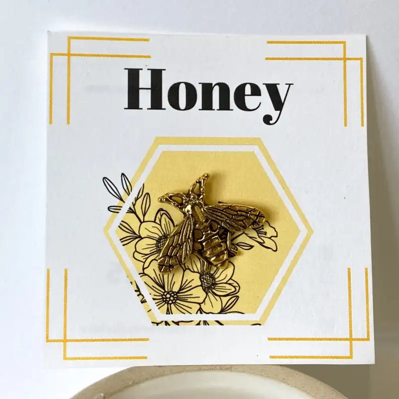 Card with honeycomb design, bee illustration, and 'Honey' text on a white background.