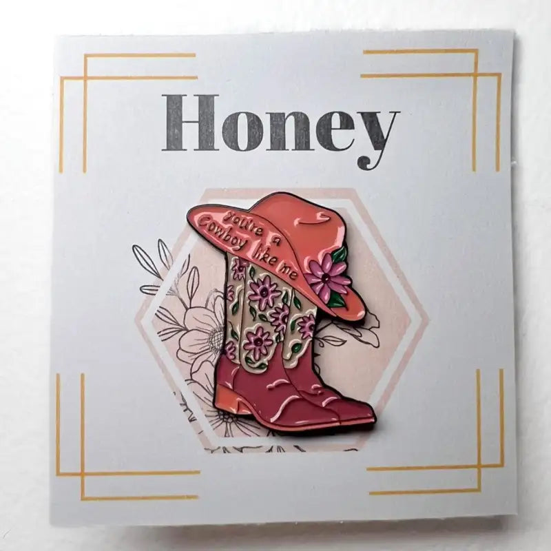 Pink cowboy boot and hat with floral design on a card with 'Honey' text