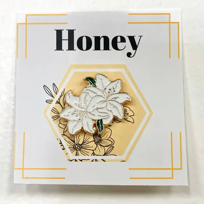 Floral pin on a card with 'Honey' text