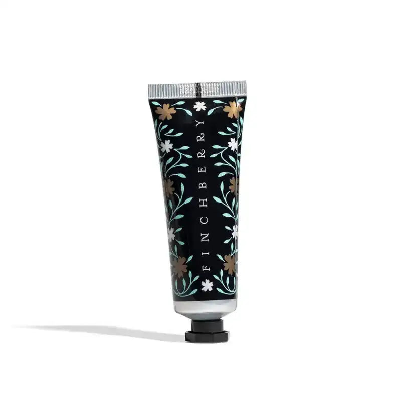 Hand cream tube with floral design and 'Finchberry' branding on a white background