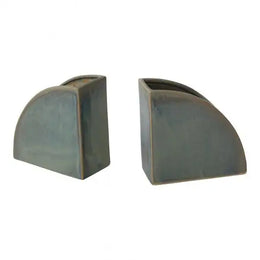 Two gray ceramic bookends on a white background