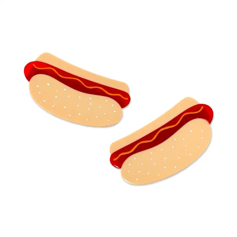 Two hot dogs with ketchup on a white background