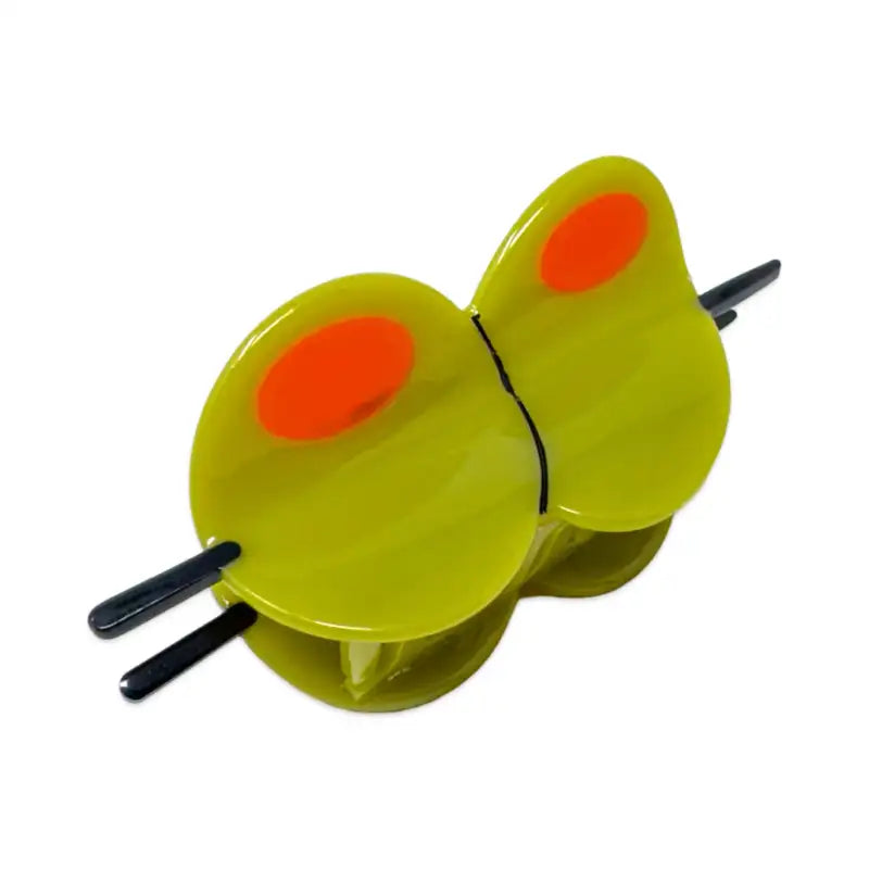 Large olive hair clip with orange spots on a white background