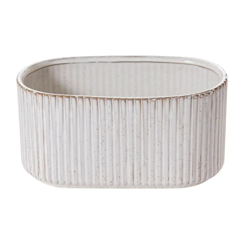 White ceramic planter with ribbed texture on a white background