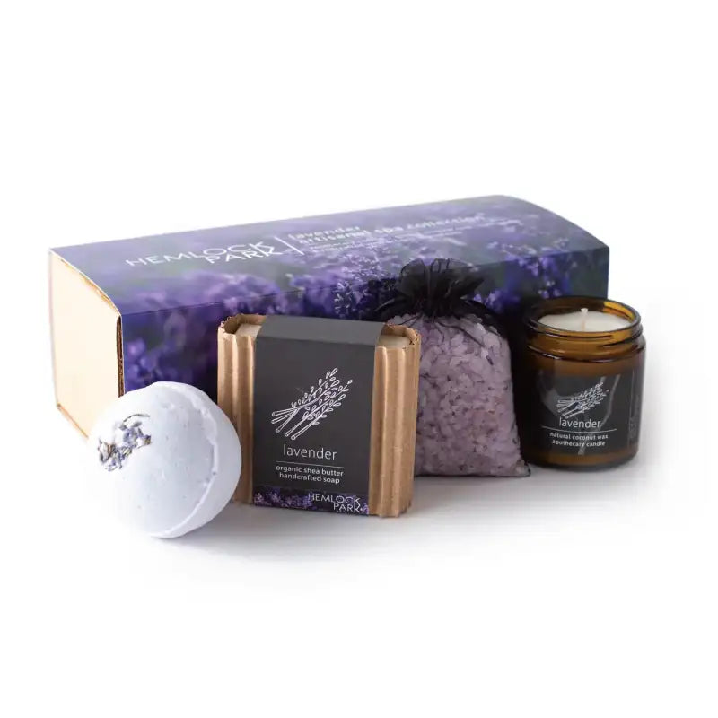 Set of lavender-themed products including a candle, soap, and bath salts on a white background.