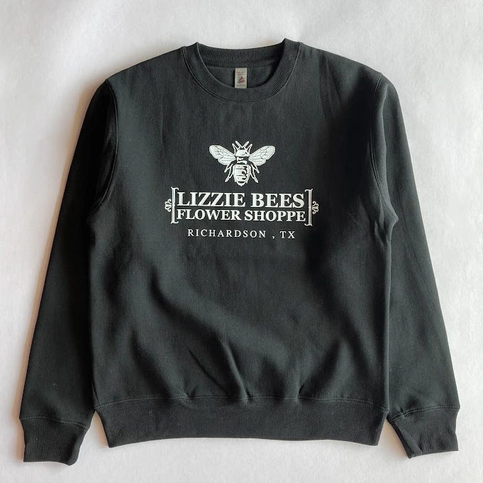 Black sweatshirt with 'Lizzie Bees Flower Shoppe' logo on a light gray background