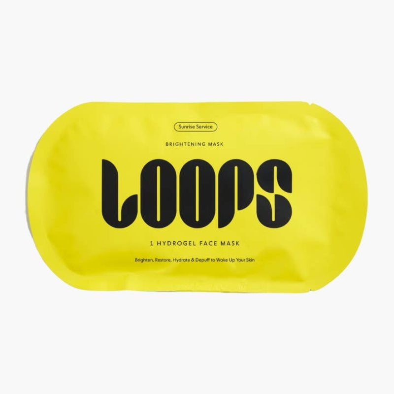 A bright yellow pouch of LOOPS Brightening Mask by Sunrise Services, featuring bold black text on a clean white background.