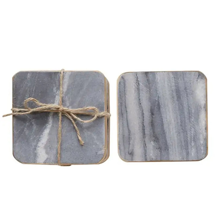 Two marble-patterned coasters tied with twine on a white background
