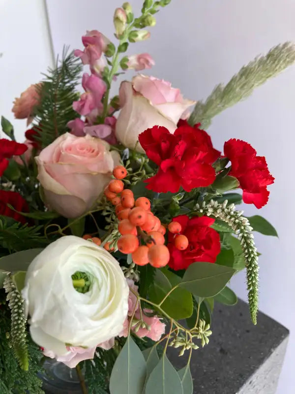 Bouquet of flowers with red, white, and pink flowers on a white background