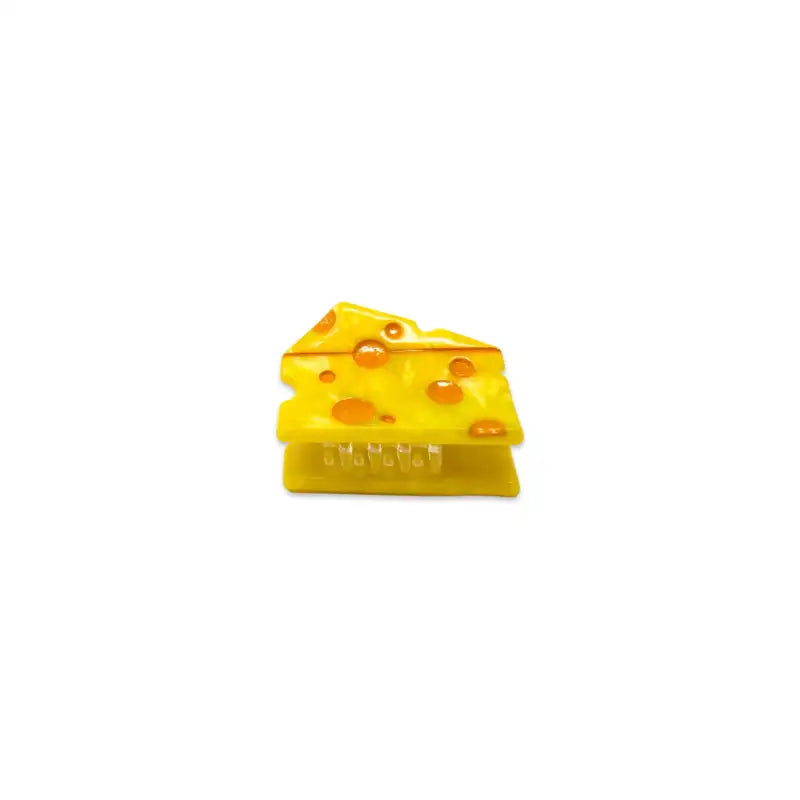 Yellow cheese wedge toy on a white background