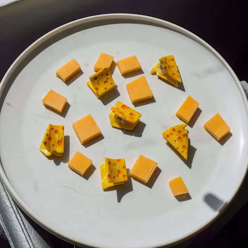 Assorted cheese hair clips on a white plate