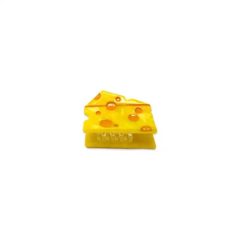 Yellow plastic cheese wedge on a white background