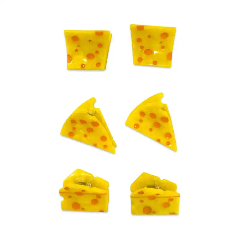 Set of yellow cheese-shaped clips on a white background