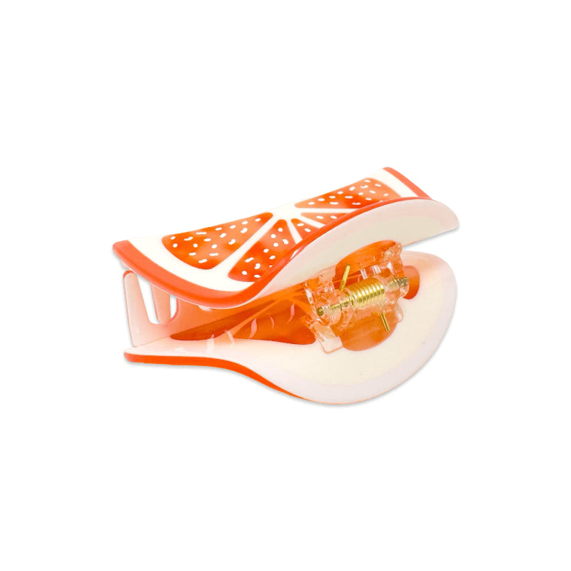 Grapefruit slice hair claw slip on a white background