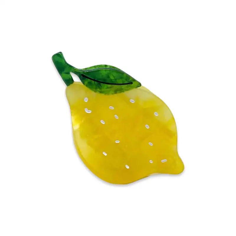 Yellow lemon-shaped hair claw with a green stem on a white background