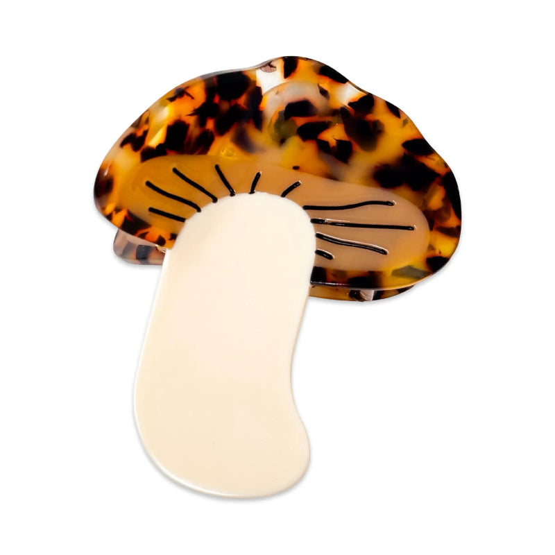 Tortoiseshell and beige hair clip on a white background