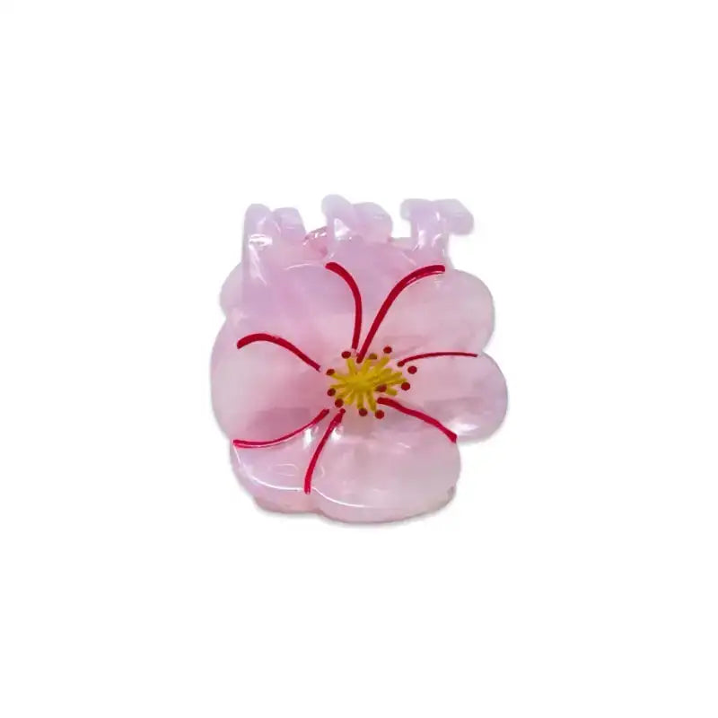 Pink flower-shaped object with a yellow center on a white background