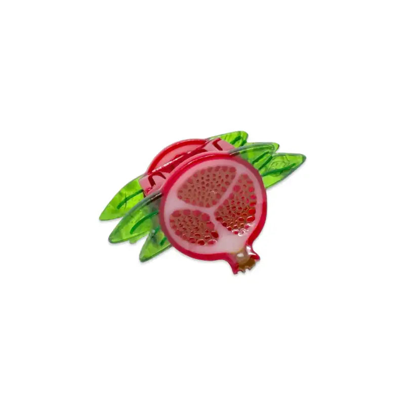 Pomegranate-shaped hair clip with green leaves on a white background