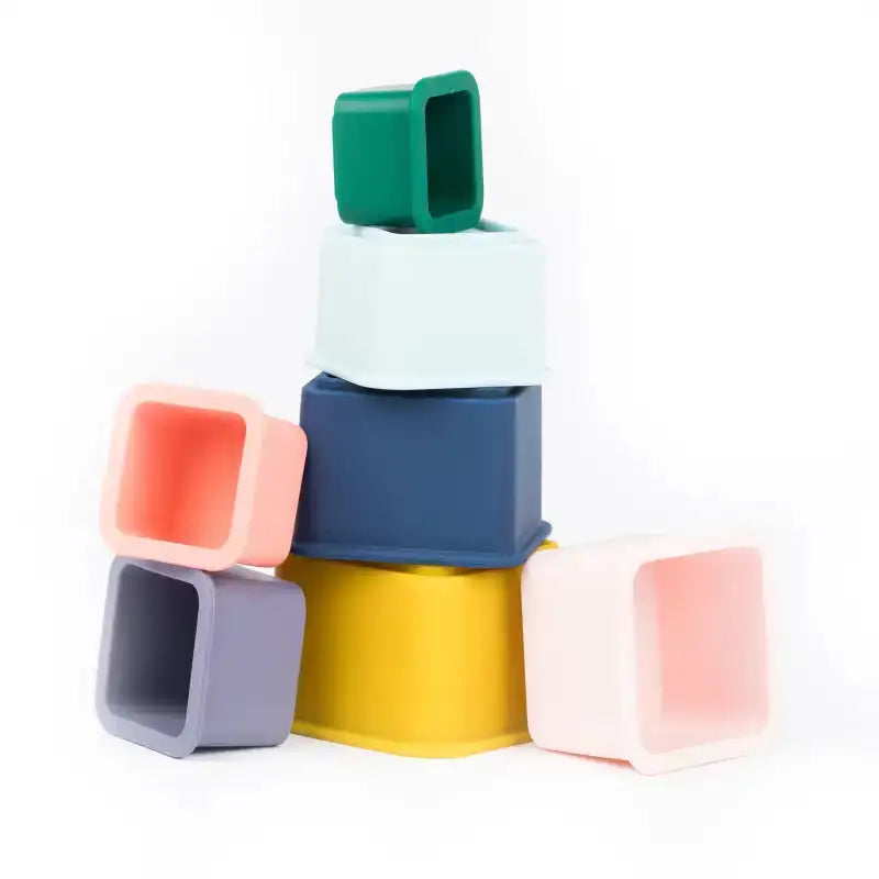 Stack of colorful plastic containers on a white background