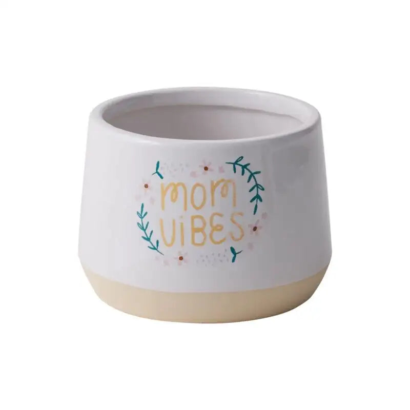 Ceramic mug with 'Mom Vibes' text on a white background