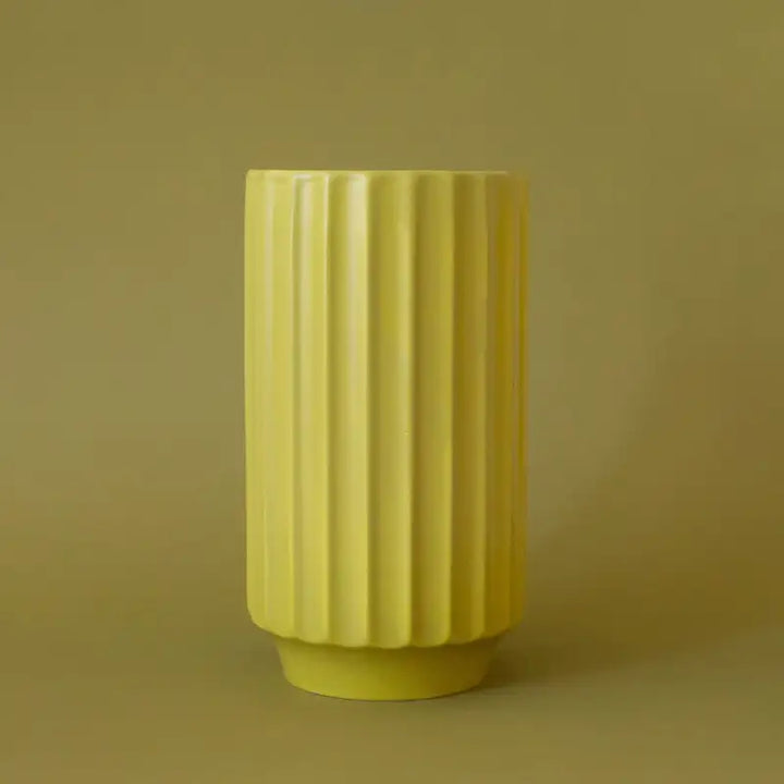 palm -ribbed monroe vase on a matching yellow background