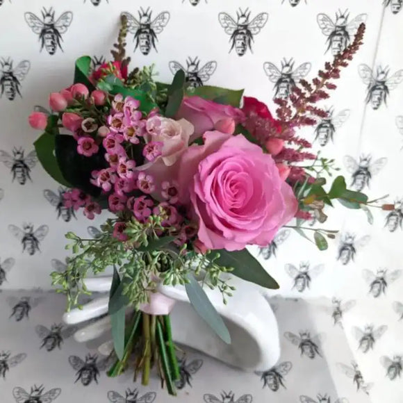 Pink rose nosegay bouquet with wax flower, berries, layered greenery, and romantic garden style