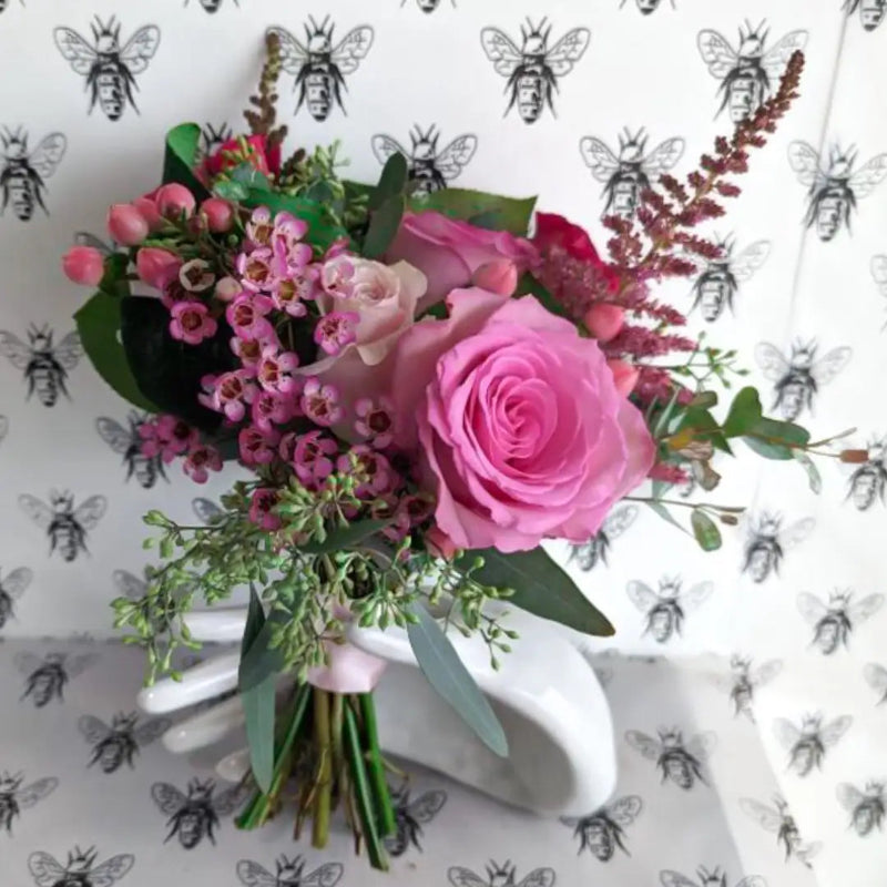 Bouquet of flowers on a white surface with a patterned background