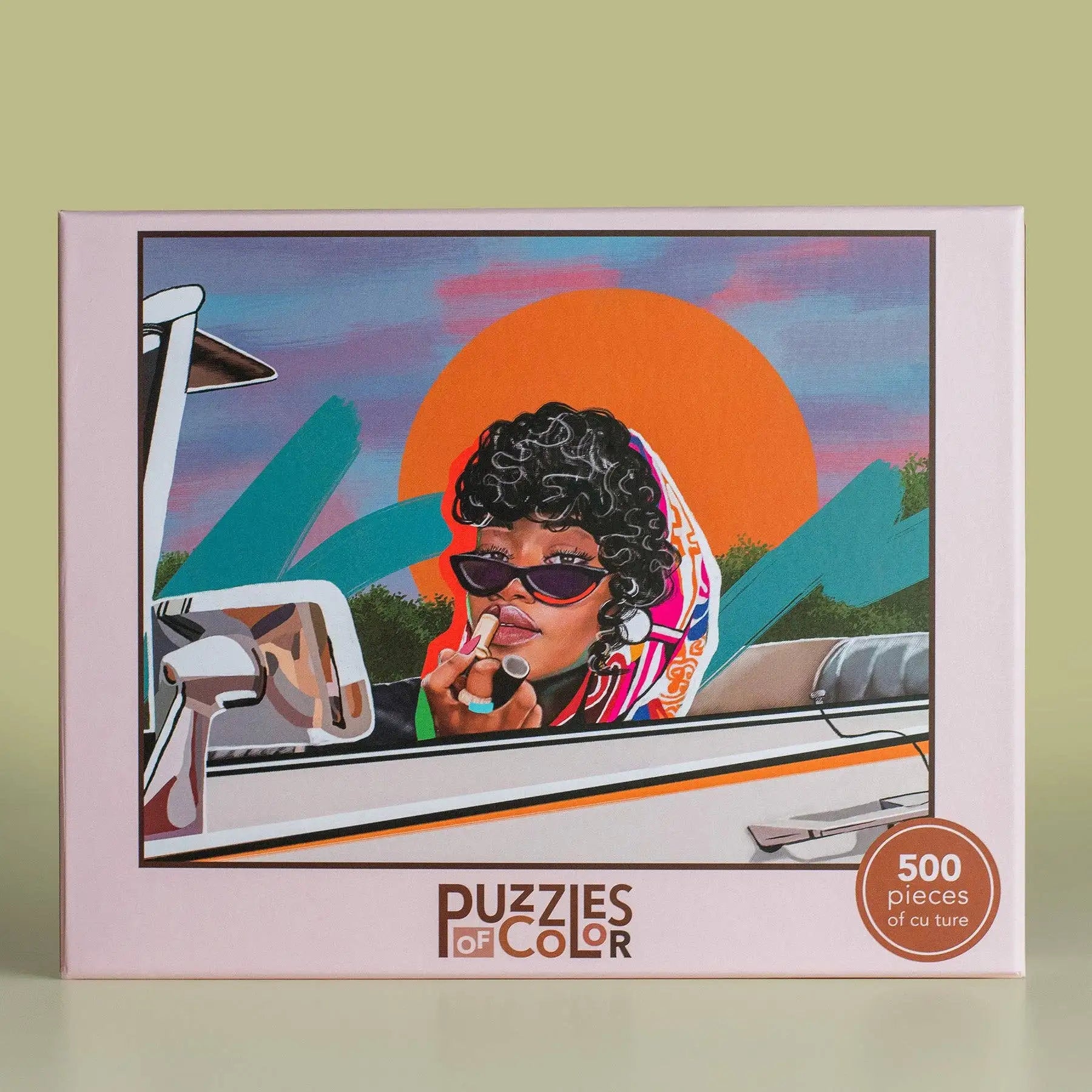 Puzzles of Color packaging with a woman in sunglasses and a colorful scarf, set against a car and sunset background.