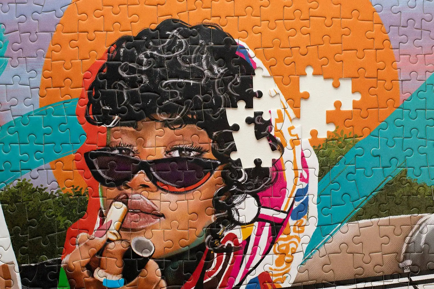 Jigsaw puzzle with a colorful portrait of a woman wearing sunglasses and a hat.