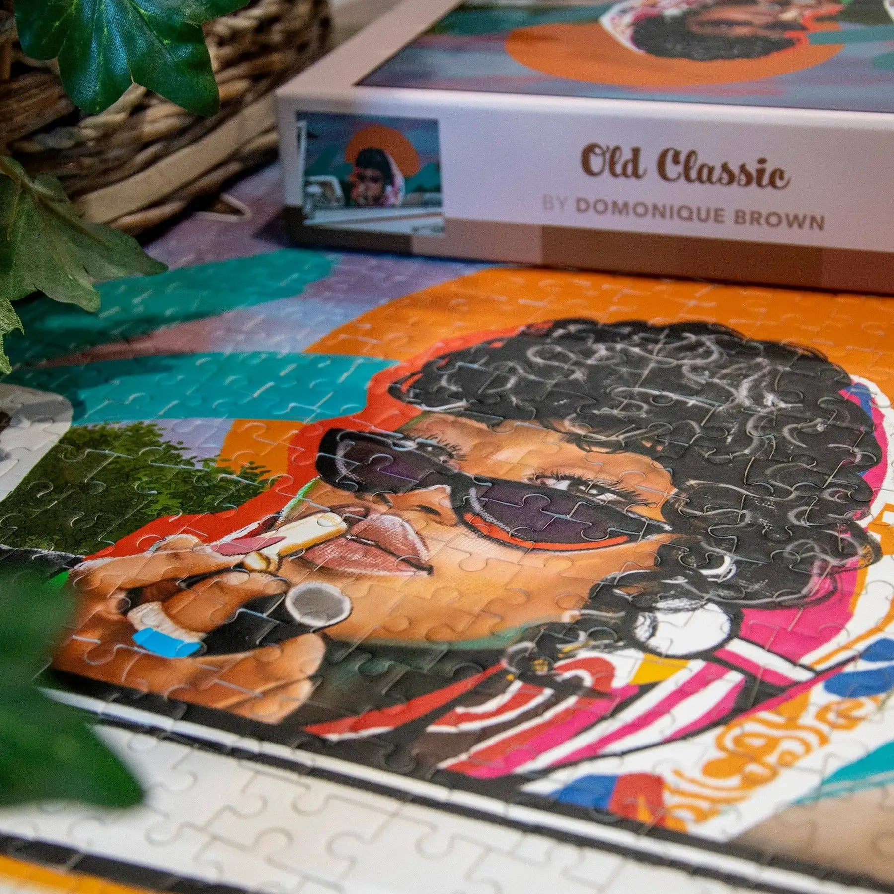 Colorful puzzle with a completed portrait of a person wearing sunglasses, surrounded by a box labeled 'Old Classic by Domonique Brown'.