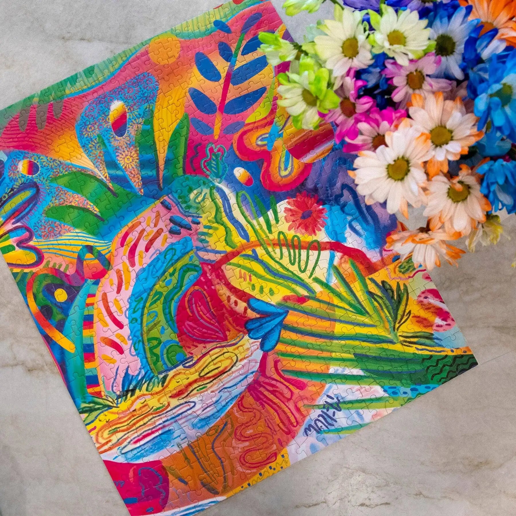 Colorful abstract artwork with floral elements on a textured surface