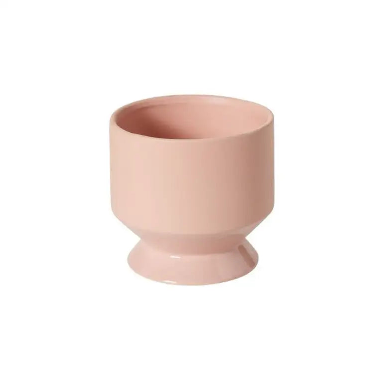 Pink ceramic cup on a white background