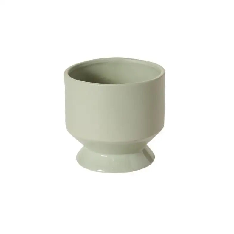 Green ceramic planter on a white background