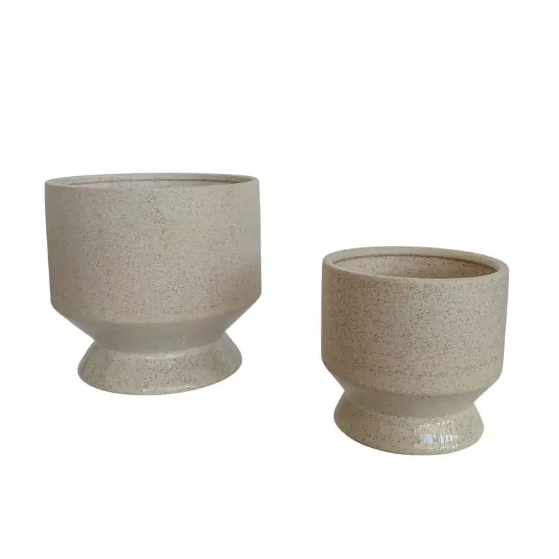 Two beige ceramic planters on a white background