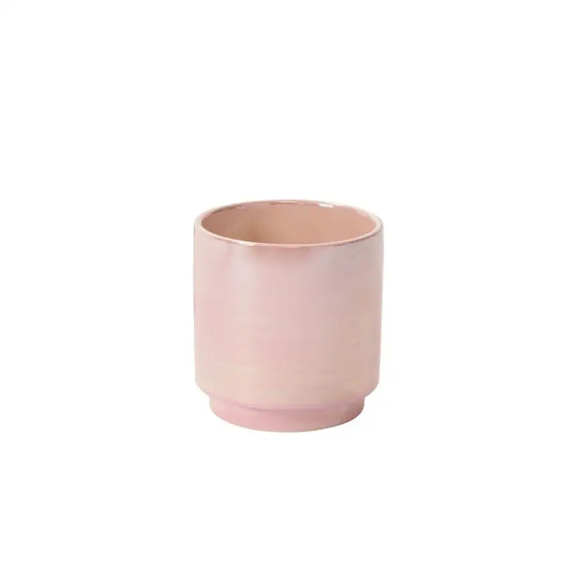 Pink ceramic cup on a white background