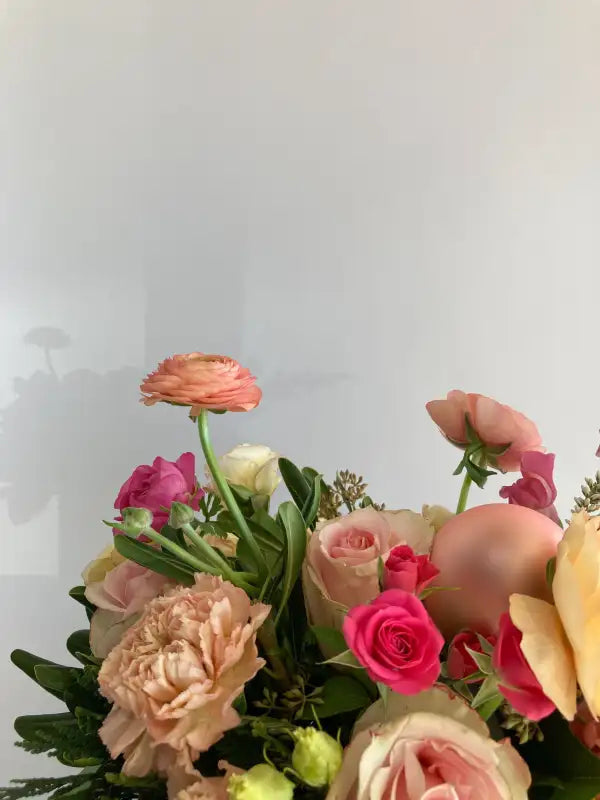 Bouquet of flowers with pink and peach colors against a white background
