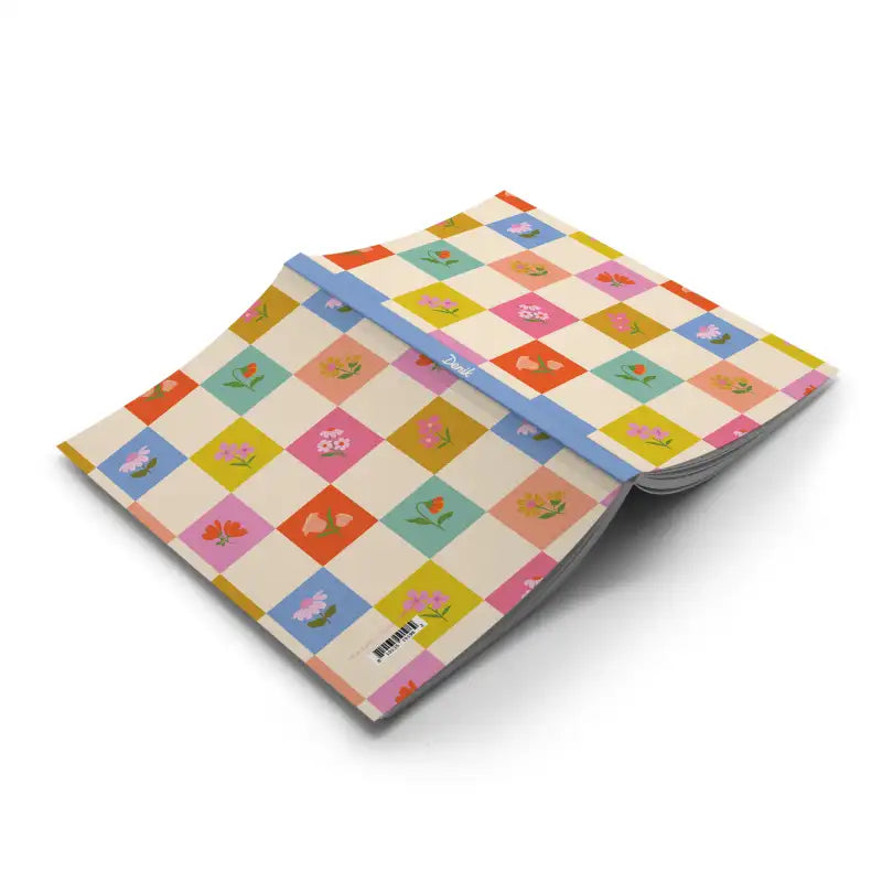 Notebook with a colorful checkered cover on a white background