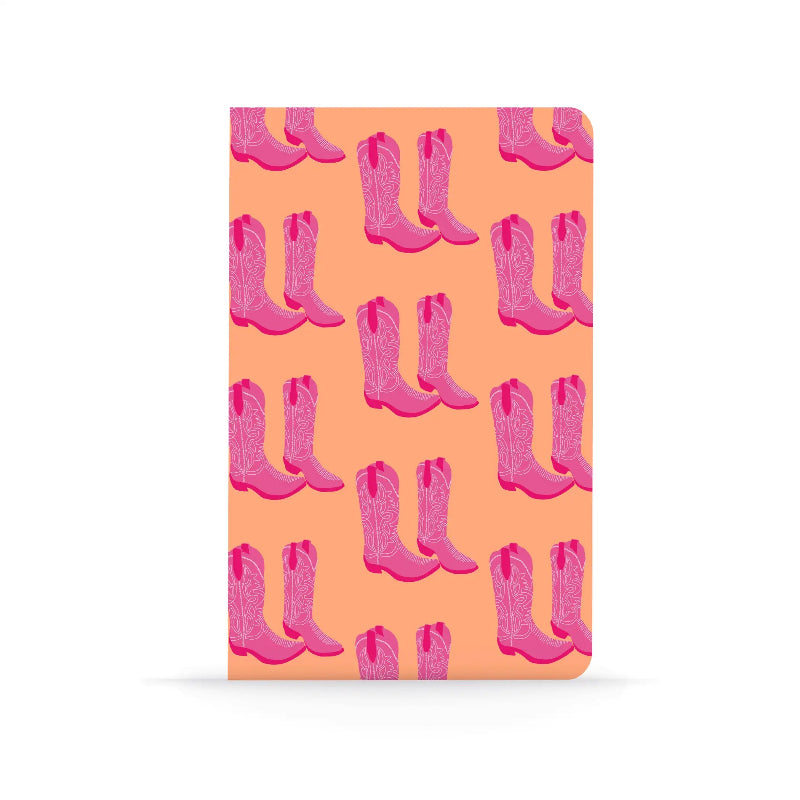 Notebook with pink cowboy boots pattern on a peach background