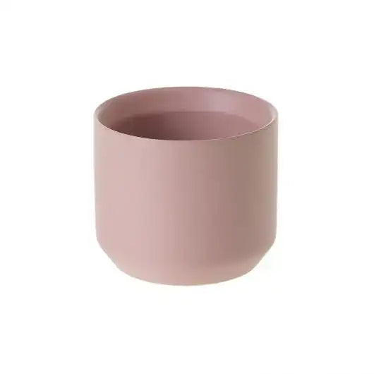 Pink ceramic cup on a white background