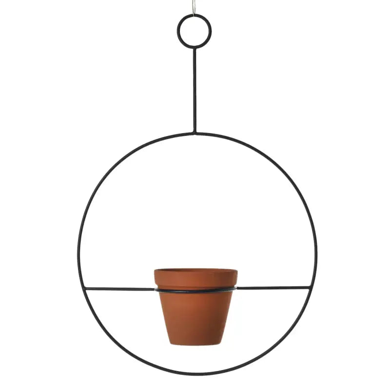 Hanging metal plant holder with a terracotta pot on a white background