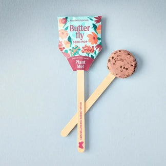 Butterfly seed pop packaging with a wooden stick and cookie-like top on a light gray background