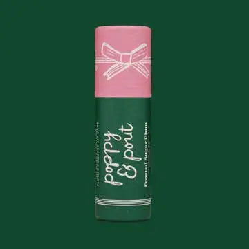 Green lip balm with pink cap on a green background