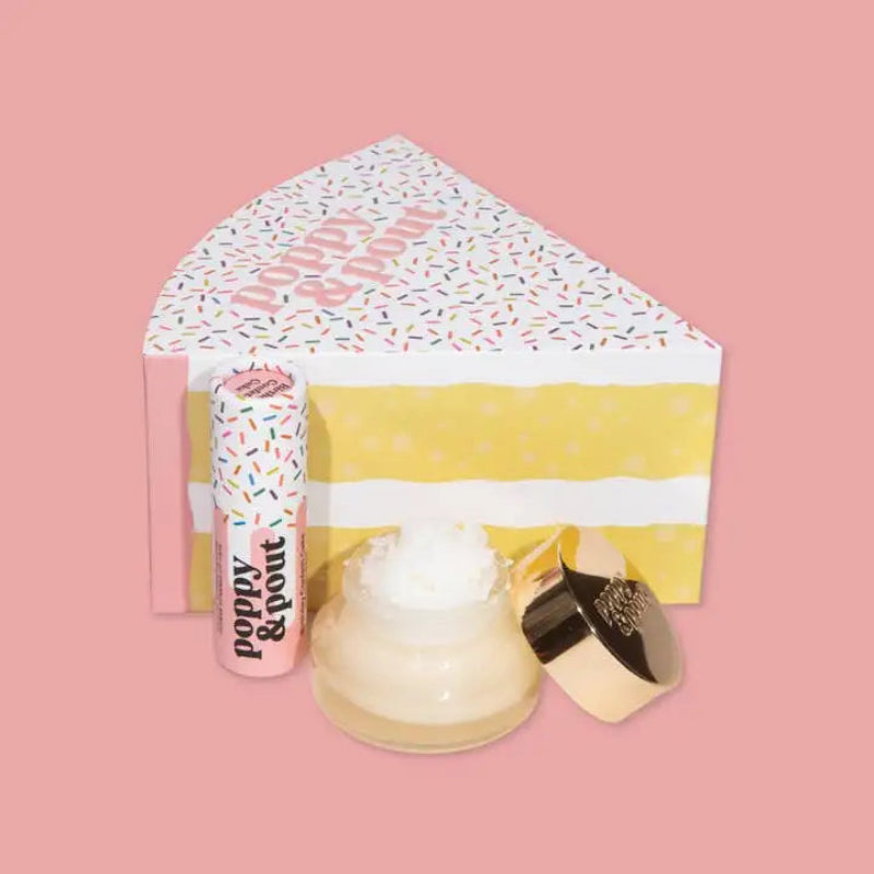 Set of lip balm and makeup items with a decorative bag on a pink background