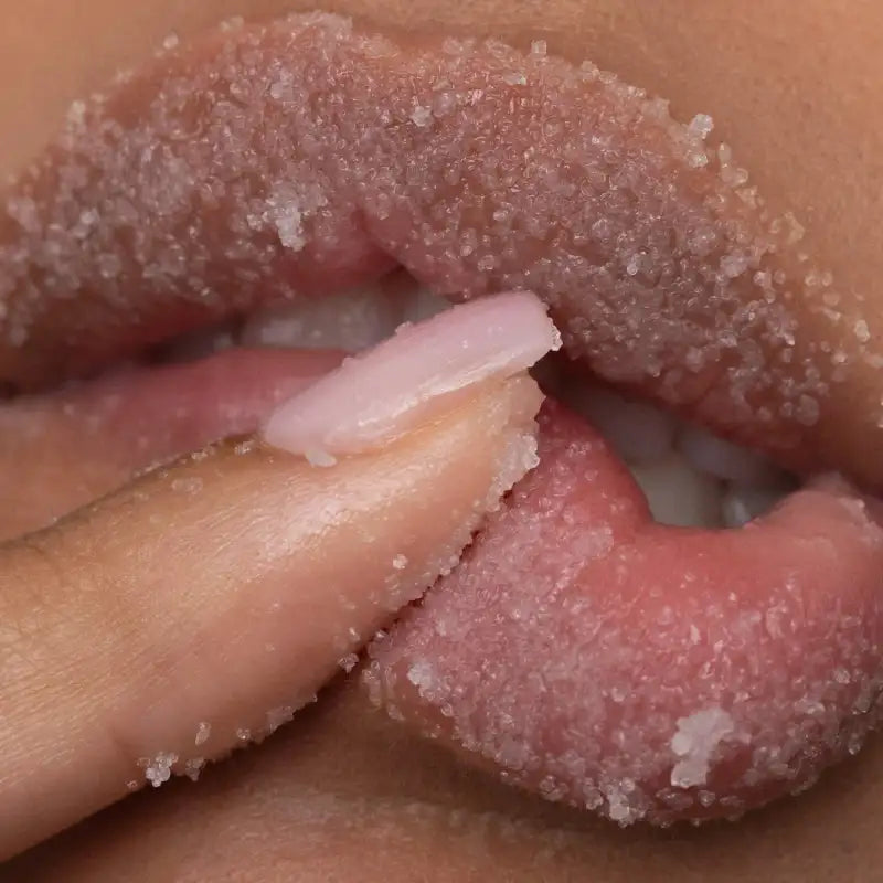 Close-up of a hand holding a pink, textured object with a blurred background