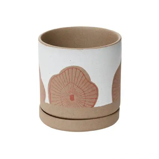 Ceramic cup with a red floral design on a white background