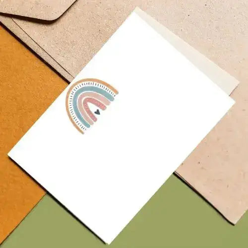 White card with a colorful rainbow design on a textured surface
