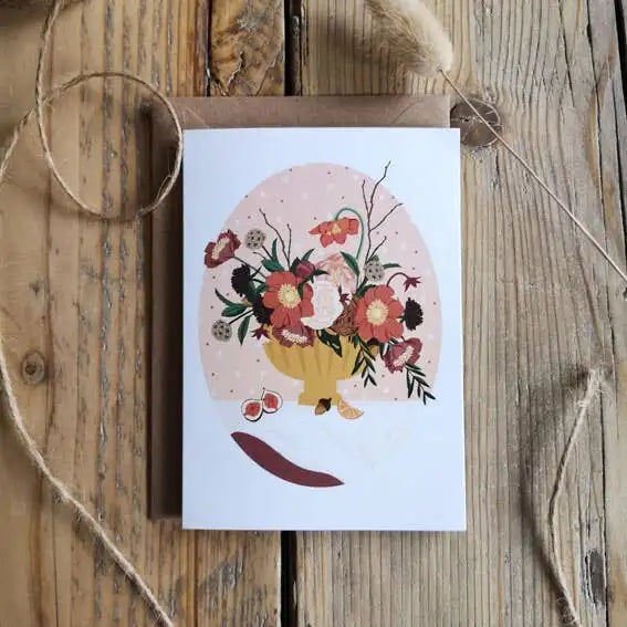 Greeting card with floral design on a wooden surface
