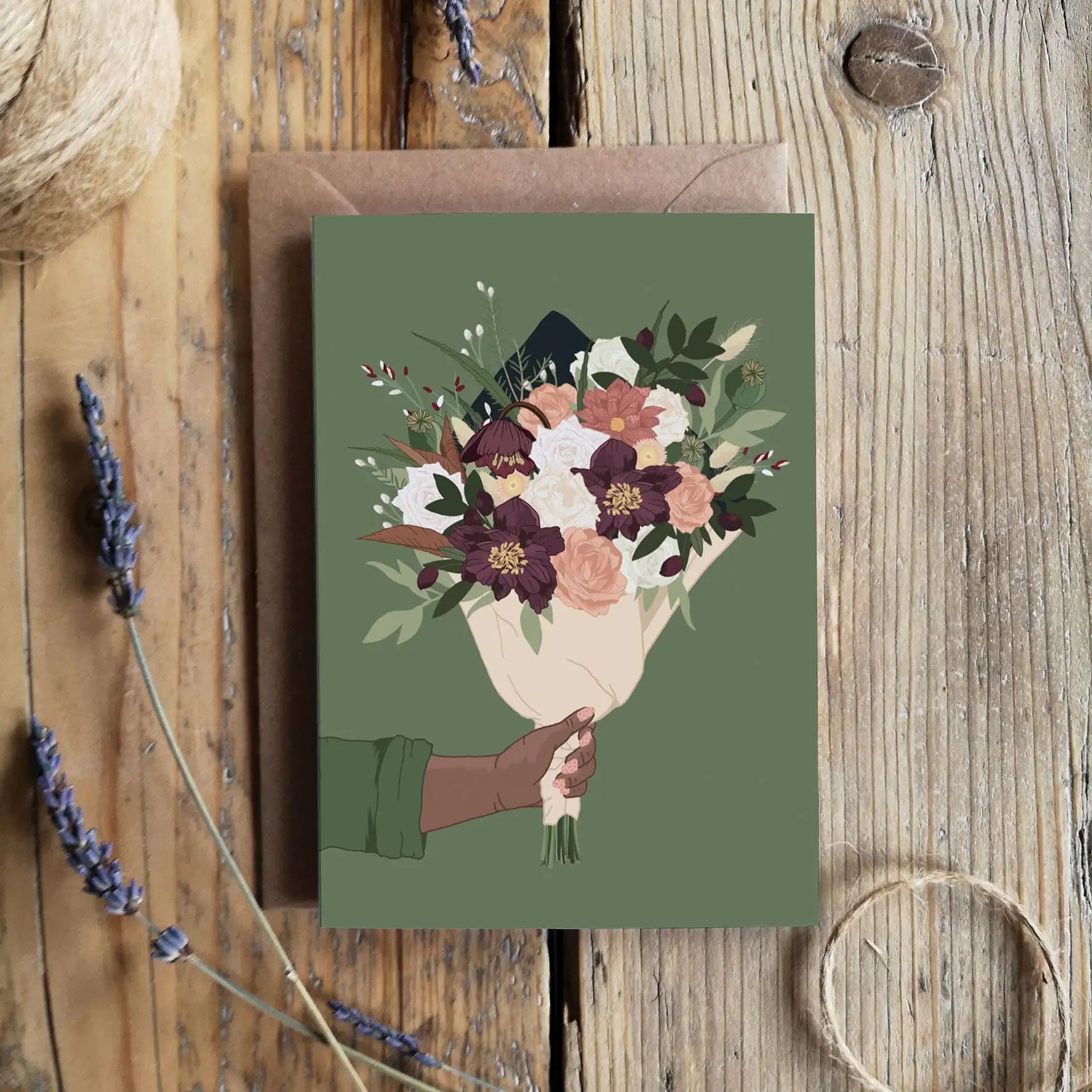 Greeting card with floral design on a wooden surface
